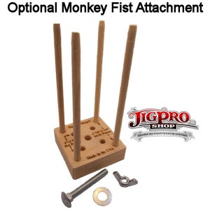 May include: A wooden jig with four dowels and a grid of holes. The jig is labeled "Made in the USA" and has the text "JigPro Shop" printed on it. The jig is used for making monkey fists. The jig is accompanied by a bolt, nut, and washer.