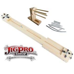May include: A wooden jig for making paracord bracelets. The jig is made of natural wood and has a long, flat surface with two grooves. There are also several metal pins for holding the paracord in place. The jig is labeled "JigPro Shop" and "Finest Built, Most Versatile Paracord Jigs on the Planet".