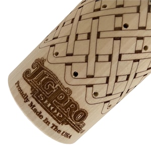 May include: A close-up of a wooden rolling pin with a decorative pattern and holes. The rolling pin is engraved with the text "JigPro&reg;  Pastry  Proudly Made in the USA".