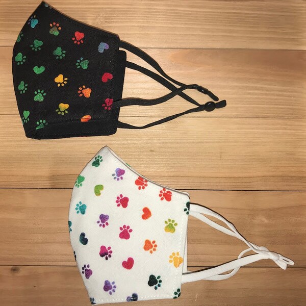 Rainbow paw print fitted face mask with adjustable ear loops and metal nose piece. Child and adult sizes available
