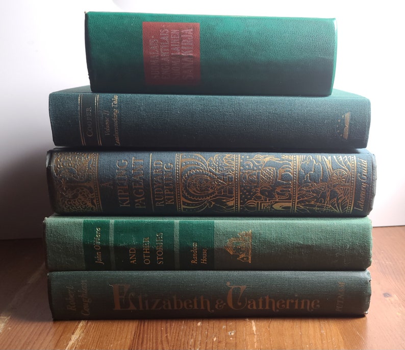 May include: A stack of five green hardcover books with gold lettering. The titles include "A Kipling Pageant", "Rudyard Kipling", "Elizabeth & Catherine", "Leatherstocking Tales", and "And Other Stories".