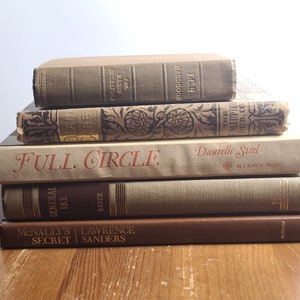 May include: A stack of six vintage hardcover books with brown and beige covers. The titles include "Full Circle" by Danielle Steel, "General Ike" by Hatch, "McNally's Secret" by Lawrence Sanders, "The Mlupto Pub. Co.", "For Radio Operators" and "I.C.S. Handbook".