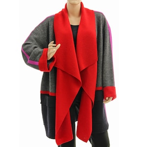 May include: A gray, red, and purple long coat with a draped red collar. The coat has purple stripes on the sleeves and red trim on the cuffs and pockets. The coat is knee-length and has a relaxed fit.