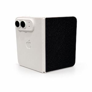 May include: A white foldable smartphone with a dual-lens camera module on the back. The device features a prominent Apple logo embossed on the white casing, while the adjacent folding panel has a textured black surface finish.