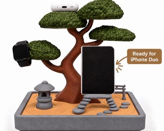 May include: A bonsai tree-shaped charging station with a brown trunk and green foliage. It features a gray base with a sand-textured surface, a stone lantern, and a stone path. Text reads: Charge up to 3 Devices and Ready for iPhone Duo.