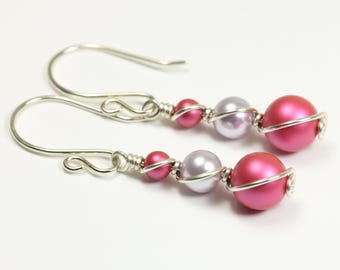 May include: Silver wire wrapped earrings with pink and lavender beads.
