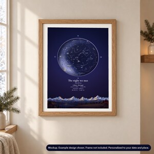 Mockup of a personalized painted-horizon star map poster shown in an oak frame in a winter setting. Frame not included.
