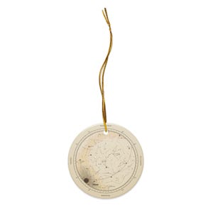 The flat round ceramic star map ornament with its gold cord, shown small.