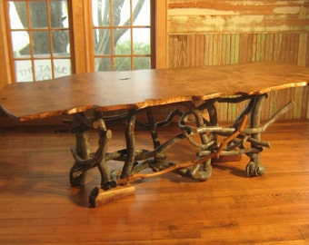 Beautiful single slab live edge maple dining table with natural organic base.