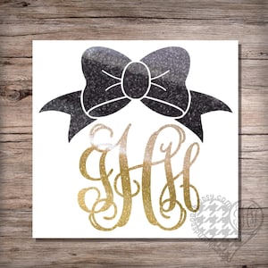 May include: A gold glitter monogram with the letters "HH" and a black glitter bow on a white background.