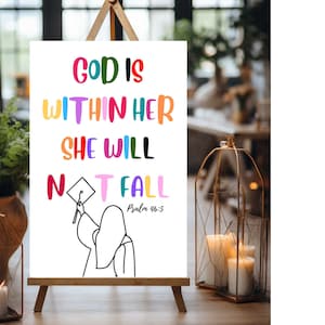 May include: A white sign with a colorful quote: "God is within her, she will not fall."  Psalm 46:5. A black and white illustration of a person wearing a graduation cap and gown.