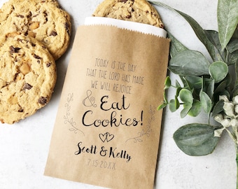 May include: A brown paper bag with a wedding favor message that reads "Today is the day that the Lord has made we will rejoice... & Eat Cookies!" with the couple's names "Scott & Kelly" and wedding date "7.15.20XX".
