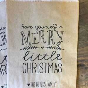 May include: Brown paper gift bag with the text "Have yourself a Merry little Christmas" and "The Beyers Family" printed on it.