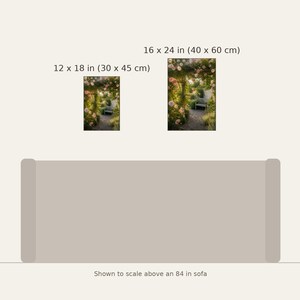 May include: Two rectangular wall art prints featuring a garden path with pink flowers and a bench. The smaller print is 12 x 18 inches and the larger is 16 x 24 inches. They are displayed above an 84 inch sofa for scale reference.