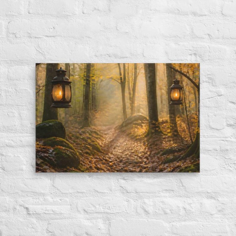 May include: A rectangular wall art print depicting a forest path covered in fallen autumn leaves. Two dark metal lanterns hang from tree branches, each emitting a warm, glowing light. The scene features tall trees and mossy rocks.