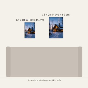 May include: Two vertical wall art prints depicting a snow-covered cabin at twilight, available in 12 x 18 inches and 16 x 24 inches, displayed to scale above an 84 inch sofa. The cabin features warm glowing windows and a chimney.