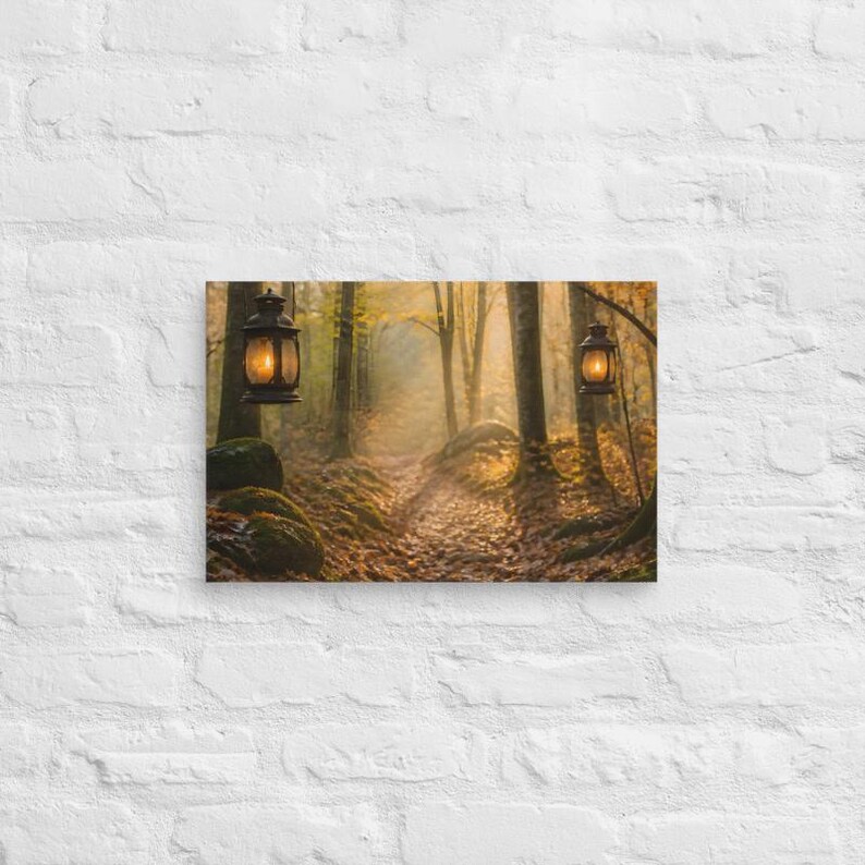 May include: A rectangular wall art print featuring a forest path covered in fallen autumn leaves. Two dark metal lanterns hang from tree branches, each emitting a warm, glowing light. The scene is filled with golden sunlight filtering through the trees.