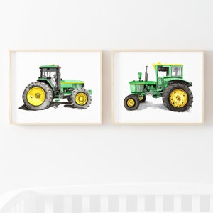 May include: Two watercolor paintings of green tractors on a white background. The tractors are both facing the left side of the image. The tractor on the left is a larger model with a yellow wheel. The tractor on the right is a smaller model with a yellow wheel and a yellow stripe on the top of the cab.