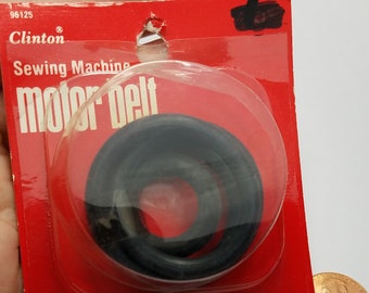 May include: A red and white package containing two black sewing machine belts. The package says "Clinton Sewing Machine motor belt" and "Made in Taiwan". The package also says "1 Motor Belt" and "1 Bobbin Winding Belt".