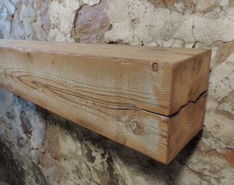 May include: A rustic wooden shelf made from reclaimed wood with a natural finish. The shelf has a rough, weathered look and is perfect for adding a touch of farmhouse charm to any room.