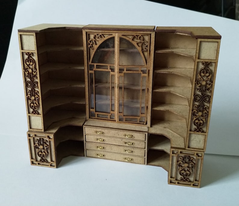 May include: A wooden corner cabinet with glass doors and intricate carvings. The cabinet has multiple shelves and drawers.