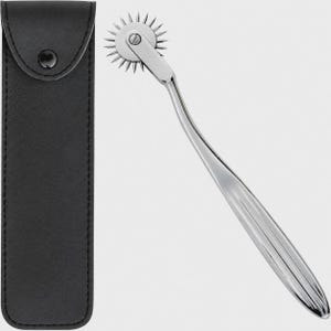 May include: A silver-colored metal Wartenberg pinwheel with a long, smooth handle and a rotating head featuring multiple sharp, radiating spikes, accompanied by a black faux leather storage pouch with a snap button closure.