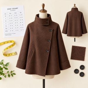 May include: A dark brown coat with a high collar, an asymmetrical button closure, and long sleeves with triple-stitched cuffs. The coat is displayed with a size chart in inches, a yellow measuring tape, and three spare black buttons.