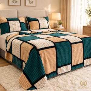 May include: A bedspread and two matching pillow shams featuring a geometric patchwork pattern in teal, beige, and white. The fabric has a textured, ribbed corduroy-like surface with black grid lines separating the rectangular color blocks.