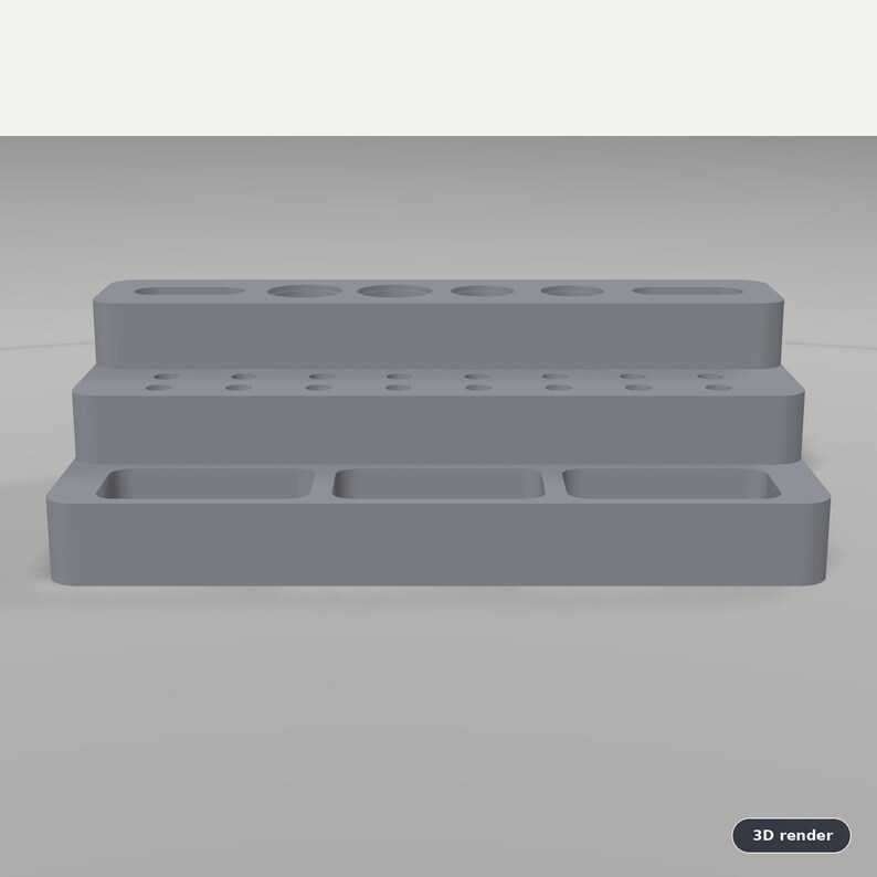 May include: A gray, three-tiered desk organizer featuring a top level with various circular and oval slots, a middle level with multiple small circular holes, and a bottom level with three rectangular compartments for storage and organization.