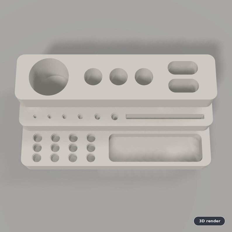 Puede incluir: Un organizador de escritorio gris claro con un dise&ntilde;o escalonado y varios recortes circulares y rectangulares. El nivel superior tiene un orificio circular grande, tres orificios circulares medianos y dos ranuras ovaladas. El nivel medio tiene seis orificios circulares peque&ntilde;os y una ranura rectangular larga. El nivel inferior incluye doce orificios circulares peque&ntilde;os y una bandeja rectangular grande.