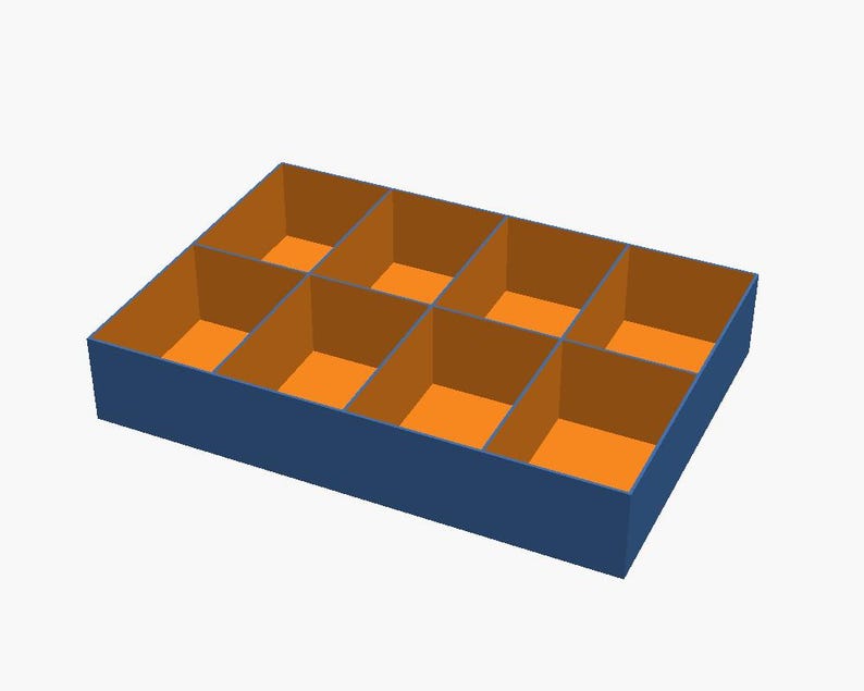 May include: A rectangular storage tray with a dark blue exterior and eight individual compartments. Each compartment features bright orange interior walls and a flat orange base, creating a grid-like organisation system for small items.
