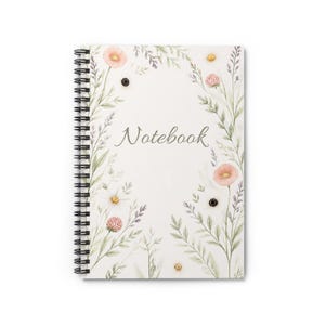 May include: A spiral-bound notebook with a white cover featuring a watercolor illustration of delicate wildflowers, green stems, and leaves. The word Notebook is printed in a cursive gray font in the center of the floral arrangement.