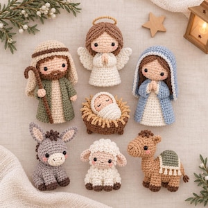 May include: A set of seven crocheted figures depicting a nativity scene, including a baby in a manger, an angel with a halo, a figure in a green robe with a staff, a figure in a blue robe, a gray donkey, a white sheep, and a brown camel.