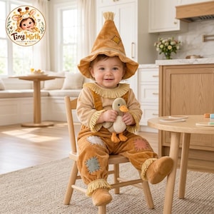May include: A tan plush scarecrow costume featuring a pointed hat, fringe collar, and decorative patches on the knees and hat. The outfit includes long sleeves and pants, and is worn with a small, soft plush duck toy held in the center.