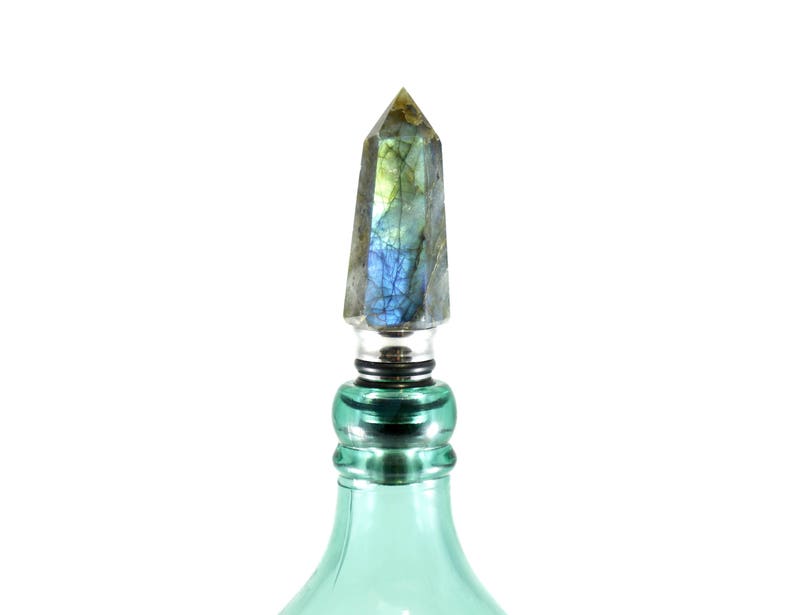 the wine stopper is on a fancy bottle of expensive liquor from the bar cabinet