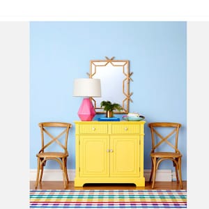 HGTV magazine used Jewelry for Your Home by Stephen D Evans mother of pearl knobs on a yellow table.  The interior design look with th pearl decor can be classic or eclectic.
