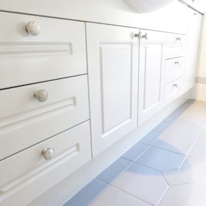 Custom made knobs in clear crystal were used by a designer in a bathroom renovation