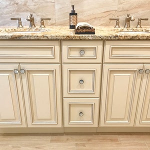 mother of pearl knobs are the finishing accent in the luxury bathroom by an interior decorator
