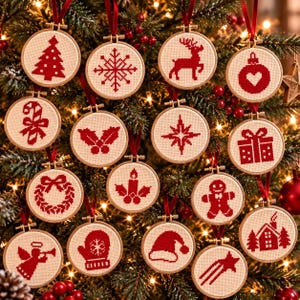 May include: A collection of fifteen round wooden embroidery hoops containing cream-colored fabric with red cross-stitch holiday designs, including a tree, snowflake, reindeer, heart, candy cane, holly, star, gift, wreath, candle, gingerbread man, angel, mitten, hat, and house.