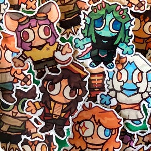 May include: A collection of die-cut stickers featuring various cartoon characters with large eyes, diverse hair colours, and distinct outfits, including figures with goggles, green skin, and pirate-style hats, all arranged in a dense, overlapping cluster.