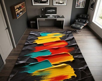 May include: A rectangular area rug featuring a black, textured background with a central design of thick, horizontal paint strokes in vibrant shades of teal, bright yellow, and bold red, creating a layered, three-dimensional visual effect.