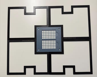 May include: A black xTool M1 small frame assembly consisting of four interlocking L-shaped pieces arranged in a square pattern. A central gray square component features a grid of small white squares and the text xTool M1-SMALL-FRAME.