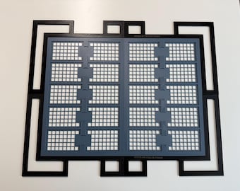 May include: A black rectangular frame with an intricate geometric border surrounds a gray grid insert. The gray insert features two vertical columns of five rectangular sections, each containing a small square grid pattern. The text XTOOL M2 FULL-RI FRAME is visible.