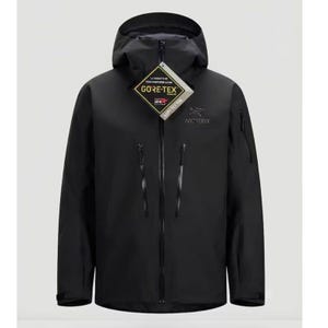May include: A black hooded jacket featuring a full-length front zip, two vertical chest pockets with black zips, and a Gore-Tex tag attached to the collar. The Arc'teryx logo is printed in grey on the upper left chest of the garment.