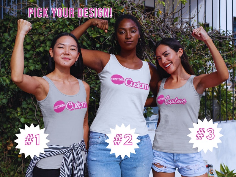 May include: Three women wearing gray tank tops with the word "Custom" printed on them in pink. The women are posing with their arms raised in the air. The tank tops are numbered 1, 2, and 3.