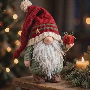 May include: A crocheted gnome figurine wearing a tall red hat with a cream pom-pom, a green striped band, and a gold star accent. The gnome has a long white beard, a round nose, a green body, and brown shoes, holding a small red gift box.