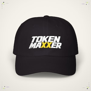 May include: A black baseball cap featuring the embroidered text TOKEN MAXXER in white, with the two X characters highlighted in a bright yellow colour. The cap has a structured crown, a curved brim, and a button at the top centre of the head.