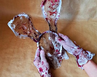 Halloween-hoofdband en -handschoenen met een sinister konijn.