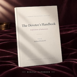 May include: A white book titled The Devotee's Handbook with the subtitle Expressions of Submission. The cover includes the text A Handbook for Devotion & Discipline, Written by AestheticPleasureAU, and A Quiet Practice of Clarity, Trust & Excellence.