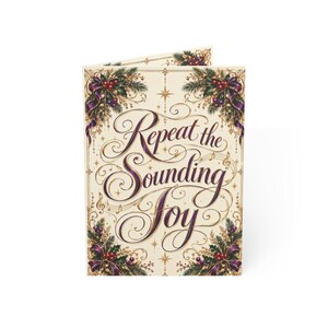 May include: A folded greeting card with a cream background featuring the text Repeat the Sounding Joy in elegant purple script. The design is framed by illustrations of green pine branches, red berries, and purple ribbons.